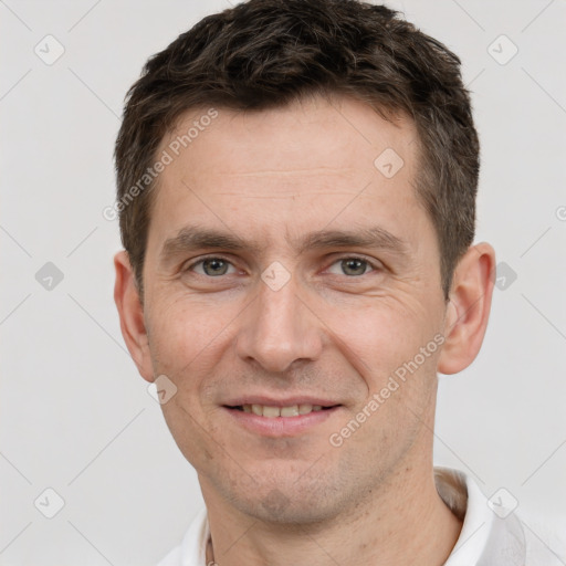 Joyful white adult male with short  brown hair and brown eyes