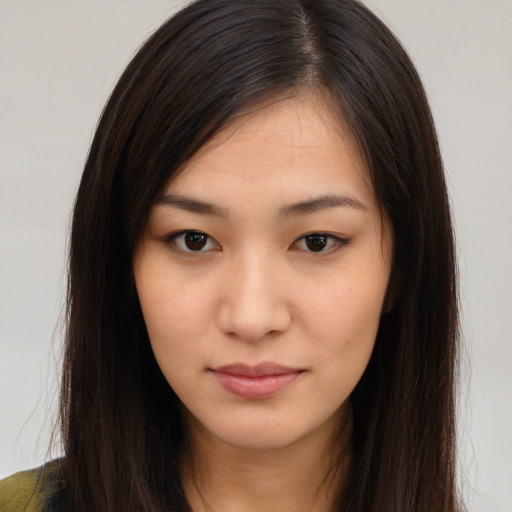 Joyful asian young-adult female with long  brown hair and brown eyes