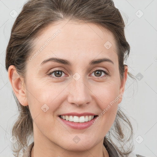 Joyful white young-adult female with medium  brown hair and grey eyes