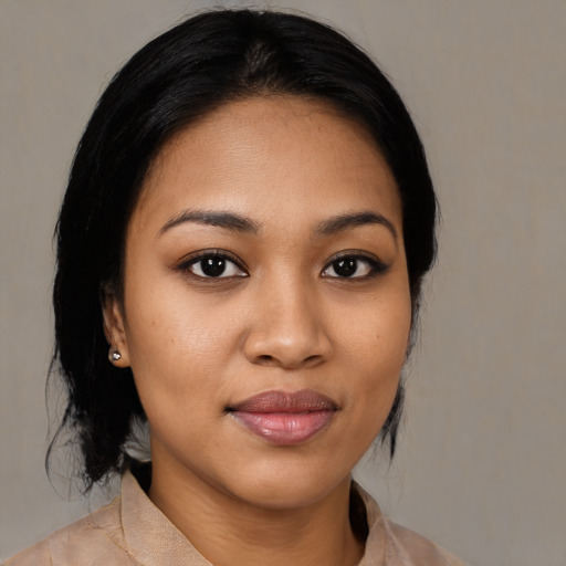 Joyful latino young-adult female with medium  black hair and brown eyes