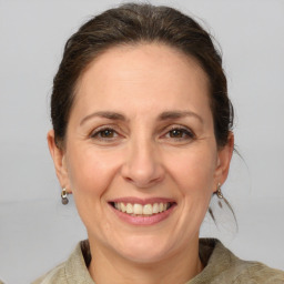 Joyful white adult female with medium  brown hair and grey eyes