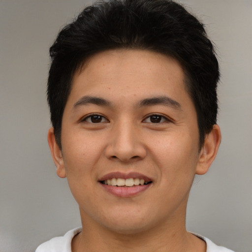 Joyful asian young-adult male with short  brown hair and brown eyes