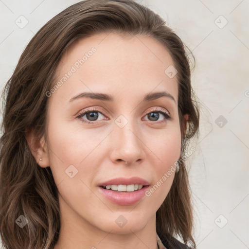 Joyful white young-adult female with long  brown hair and blue eyes