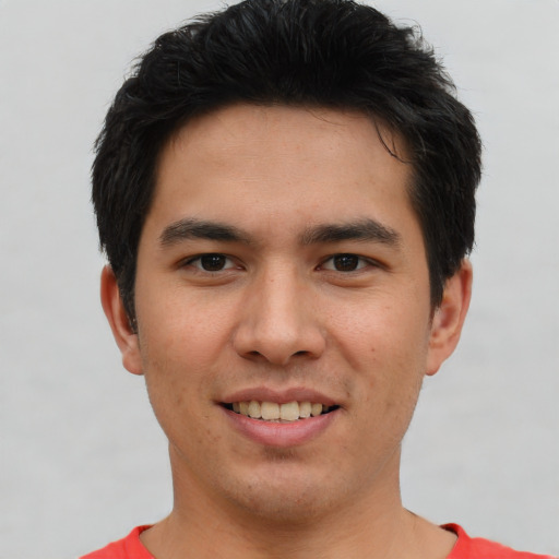 Joyful asian young-adult male with short  brown hair and brown eyes