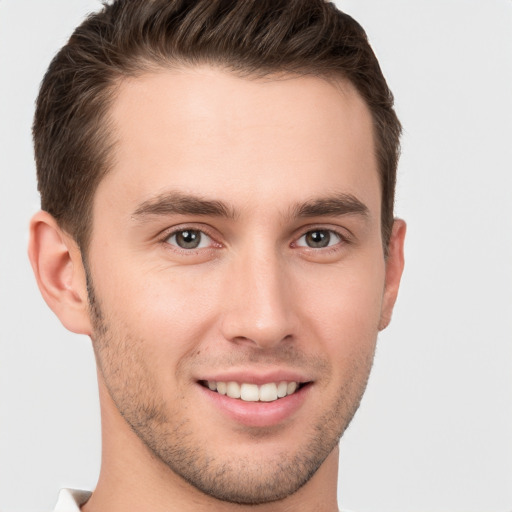 Joyful white young-adult male with short  brown hair and brown eyes