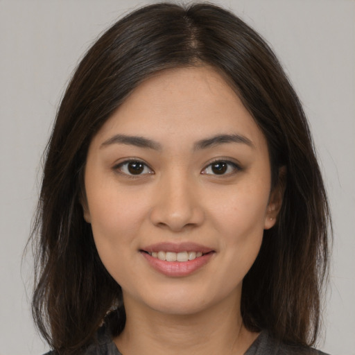 Joyful white young-adult female with long  brown hair and brown eyes