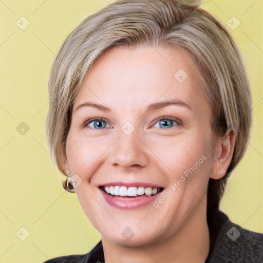 Joyful white young-adult female with medium  brown hair and blue eyes