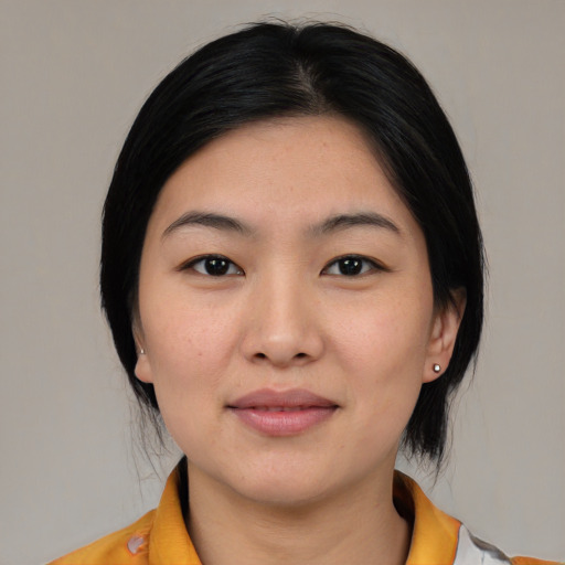 Joyful asian young-adult female with medium  black hair and brown eyes