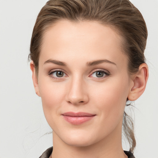 Joyful white young-adult female with long  brown hair and grey eyes