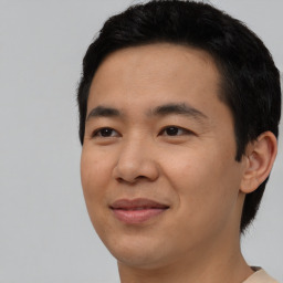 Joyful asian young-adult male with short  black hair and brown eyes