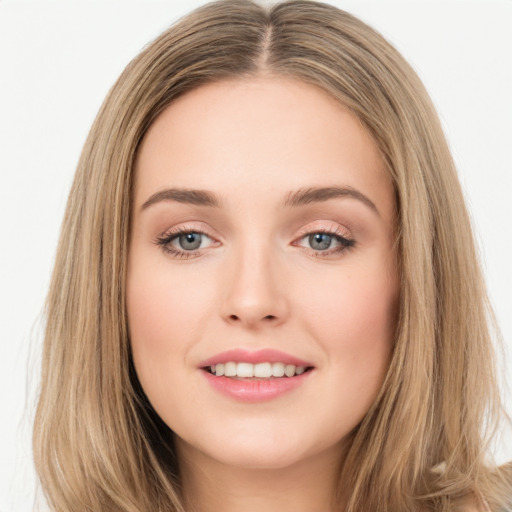 Joyful white young-adult female with long  brown hair and green eyes