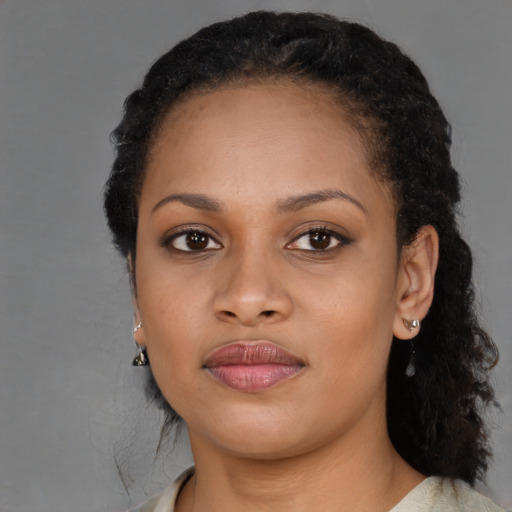 Joyful black young-adult female with medium  brown hair and brown eyes