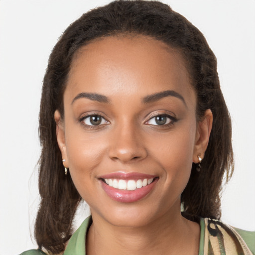 Joyful latino young-adult female with long  brown hair and brown eyes