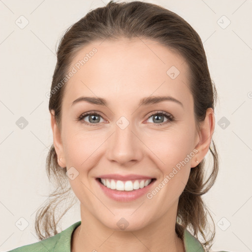 Joyful white young-adult female with medium  brown hair and green eyes