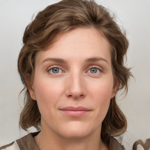 Joyful white young-adult female with medium  brown hair and blue eyes