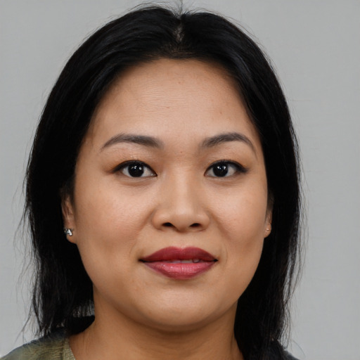 Joyful asian young-adult female with medium  brown hair and brown eyes