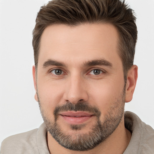 Joyful white young-adult male with short  brown hair and brown eyes