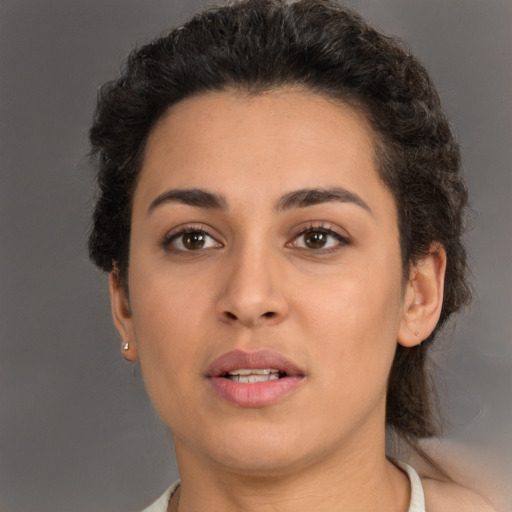 Joyful latino young-adult female with short  brown hair and brown eyes