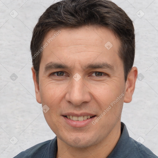 Joyful white adult male with short  brown hair and brown eyes