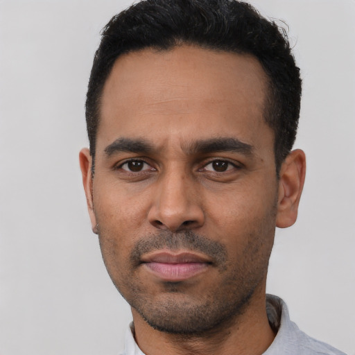 Neutral latino young-adult male with short  black hair and brown eyes