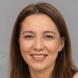 Joyful white adult female with long  brown hair and brown eyes