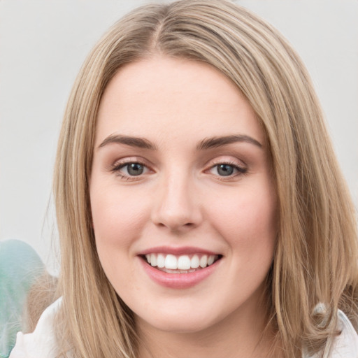 Joyful white young-adult female with long  brown hair and green eyes