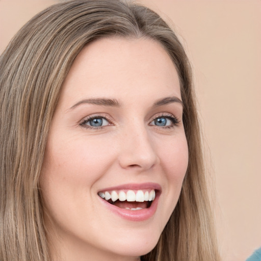 Joyful white young-adult female with long  brown hair and green eyes