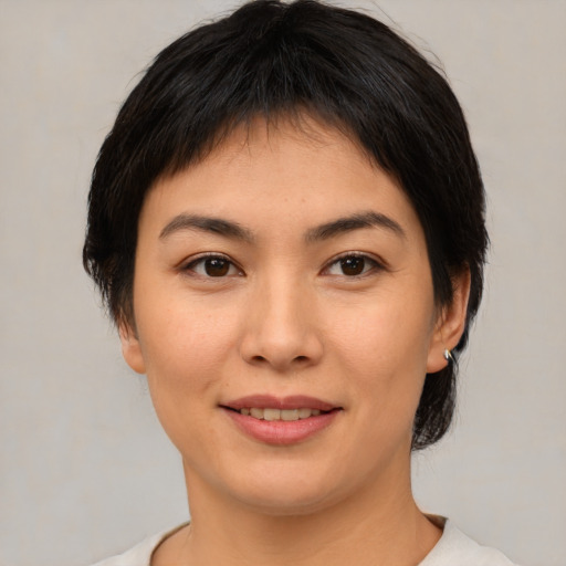 Joyful asian young-adult female with medium  brown hair and brown eyes