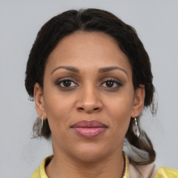 Joyful latino young-adult female with medium  brown hair and brown eyes