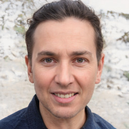 Joyful white adult male with short  brown hair and grey eyes