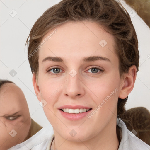 Joyful white young-adult female with short  brown hair and blue eyes