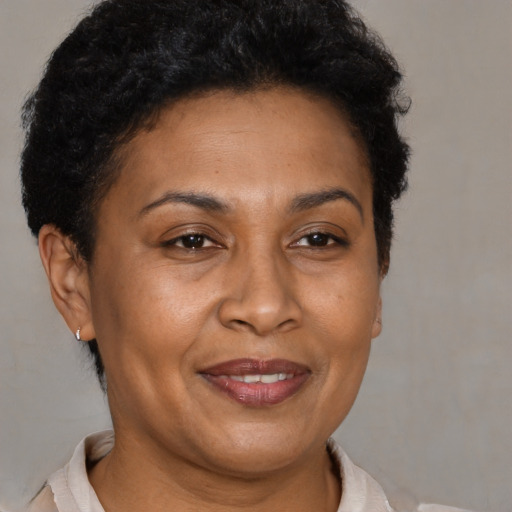 Joyful latino adult female with short  brown hair and brown eyes