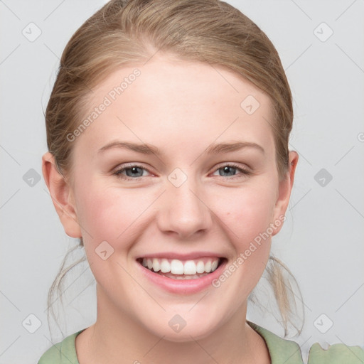 Joyful white young-adult female with medium  brown hair and blue eyes