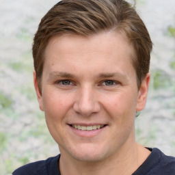 Joyful white young-adult male with short  brown hair and grey eyes