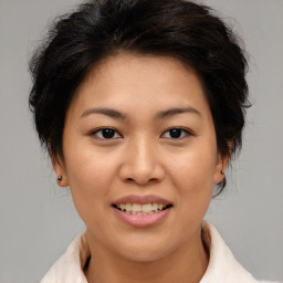 Joyful asian young-adult female with medium  brown hair and brown eyes