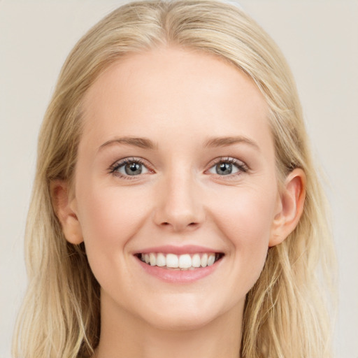 Joyful white young-adult female with long  brown hair and blue eyes