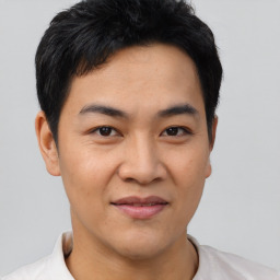 Joyful asian young-adult male with short  black hair and brown eyes