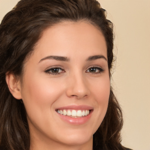 Joyful white young-adult female with long  brown hair and brown eyes