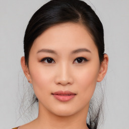 Joyful asian young-adult female with medium  black hair and brown eyes