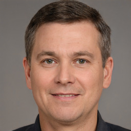 Joyful white adult male with short  brown hair and grey eyes