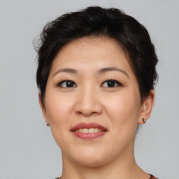 Joyful asian young-adult female with short  brown hair and brown eyes