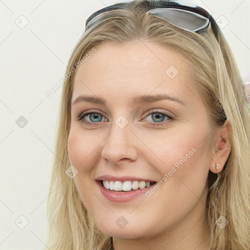 Joyful white young-adult female with long  brown hair and blue eyes