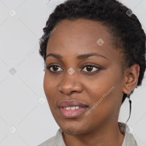 Joyful black young-adult female with short  black hair and brown eyes