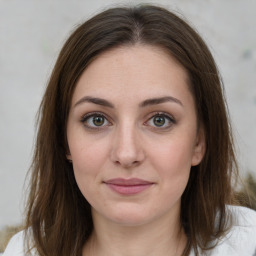 Joyful white young-adult female with medium  brown hair and green eyes