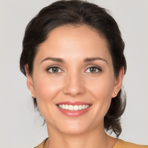 Joyful white young-adult female with medium  brown hair and brown eyes