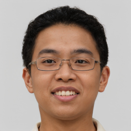 Joyful asian young-adult male with short  brown hair and brown eyes