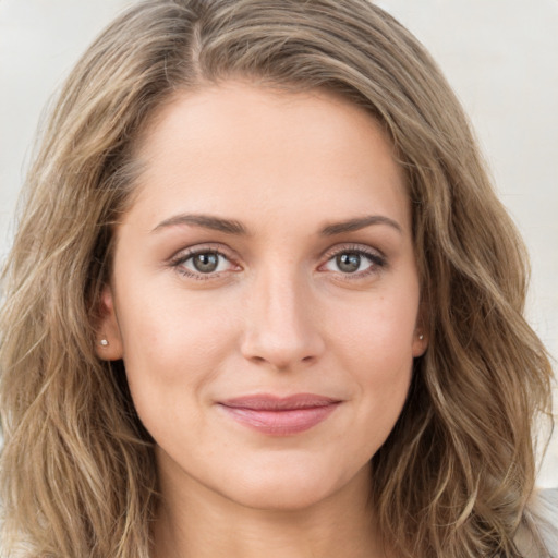 Joyful white young-adult female with long  brown hair and green eyes