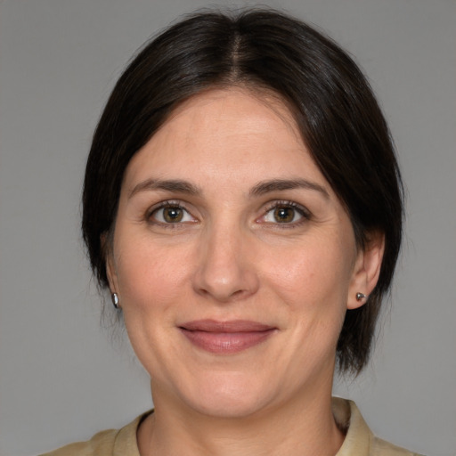 Joyful white adult female with medium  brown hair and brown eyes