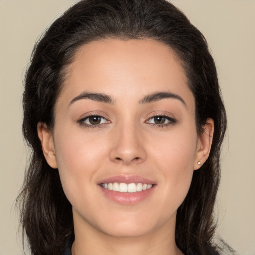 Joyful white young-adult female with long  brown hair and brown eyes