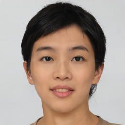 Joyful asian young-adult female with short  black hair and brown eyes